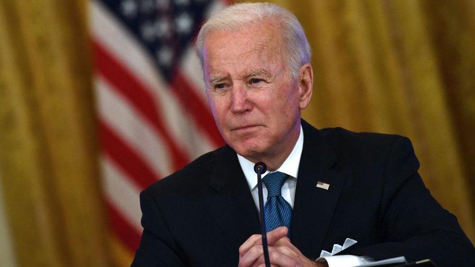 US president Joe Biden, with USA flag behind