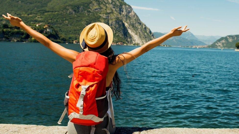 Traveller in front of lake