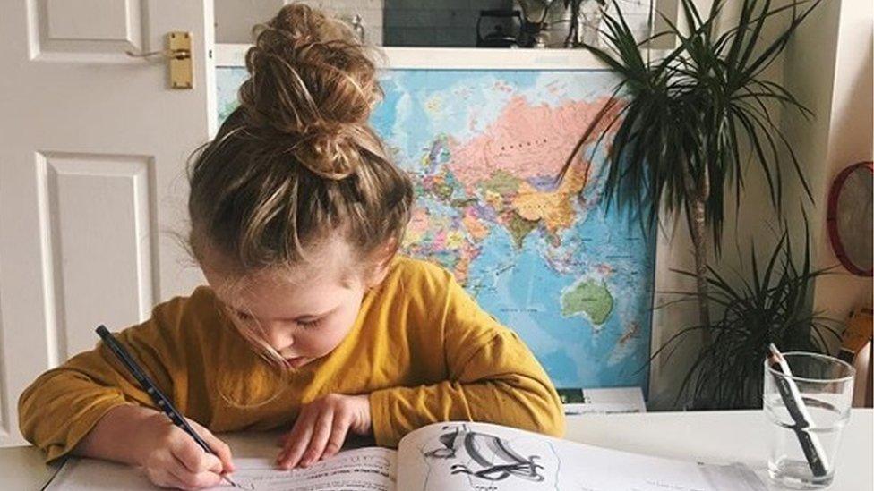 Girl writing at a table