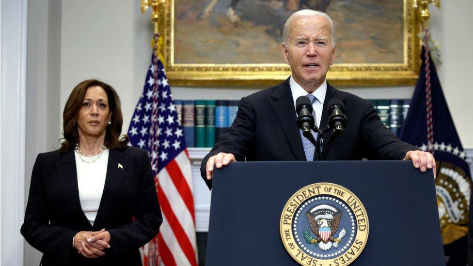 Kamala Harris standing behind US President Joe Biden