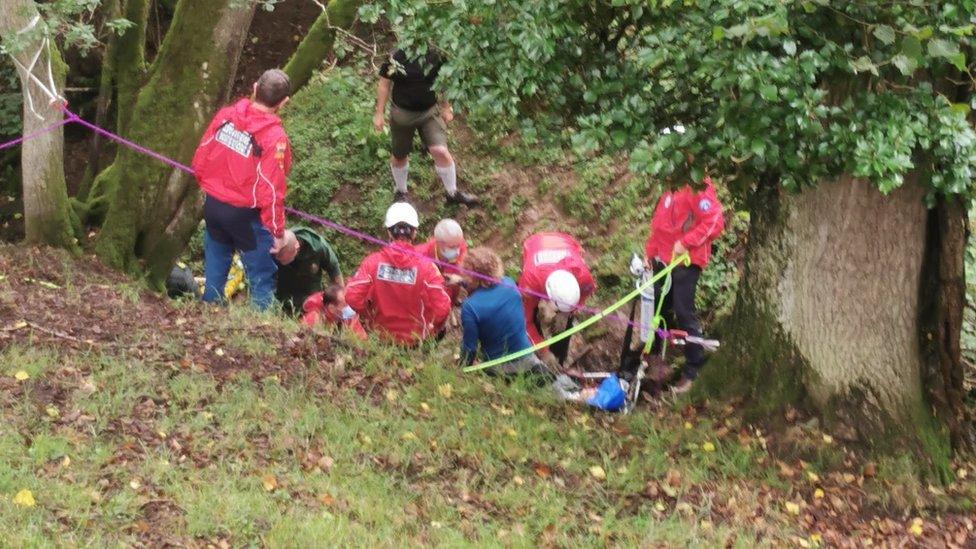 The rescue team with the man in the ravine