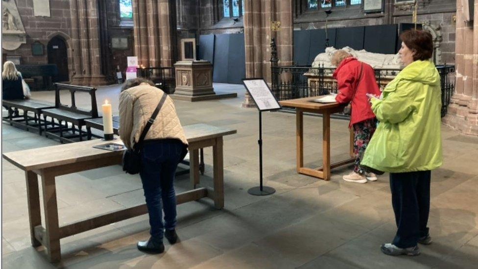 People signing book of condolence at Chester Cathedral