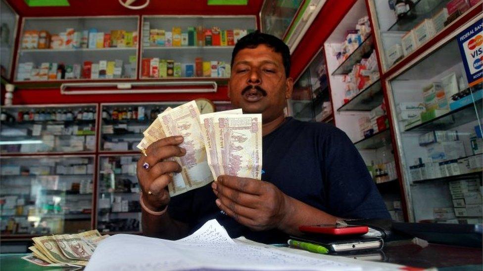 A shopkeeper counts 500 Indian rupee banknotes at a cash counter inside a medicine shop in Agartala, India, November 9, 2016