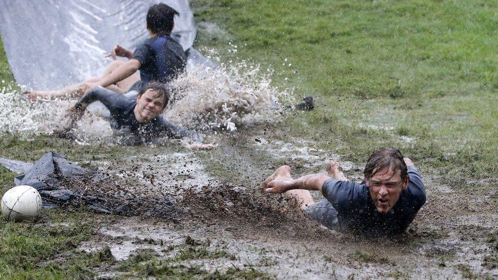 Boys slide in mud in New South Wales