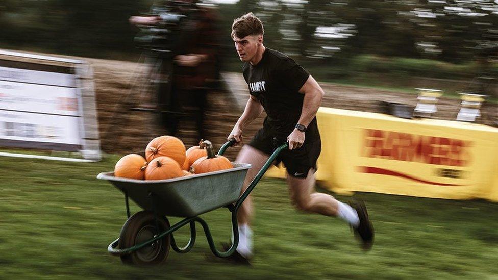 James wheels a barrow of pumpkins