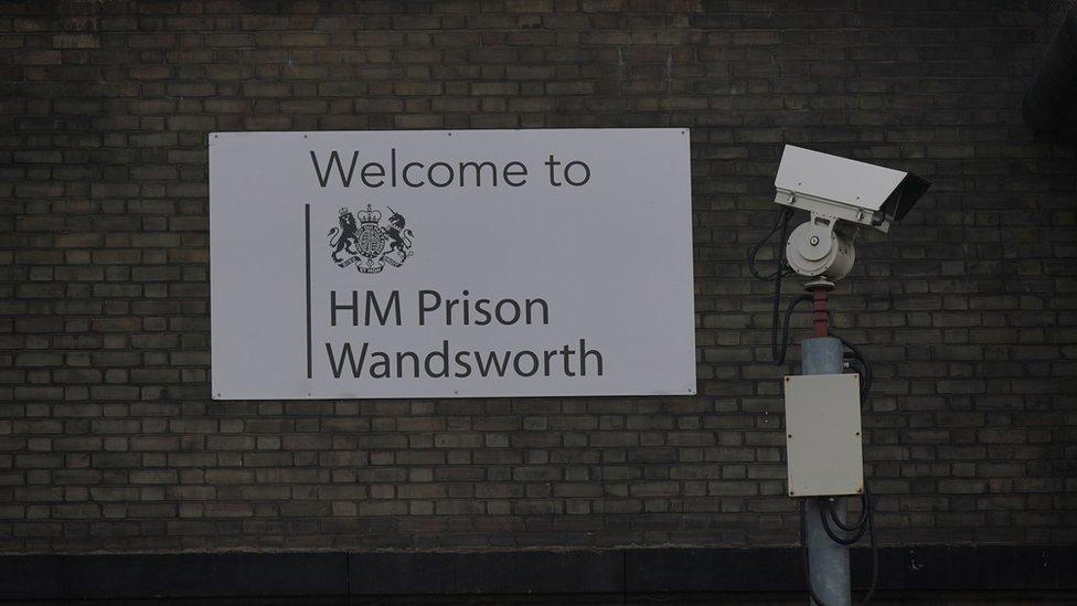 A general view of signage and security cameras at HMP Wandsworth in London,