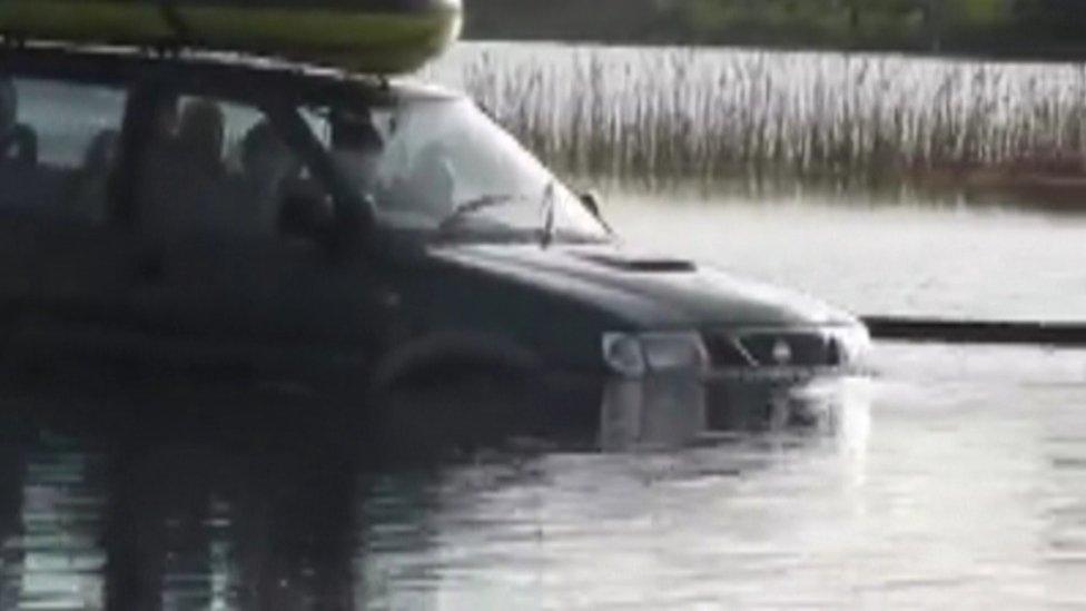 The family have been driving though floods, trying to avoid a deep drain along the side of the laneway to their home