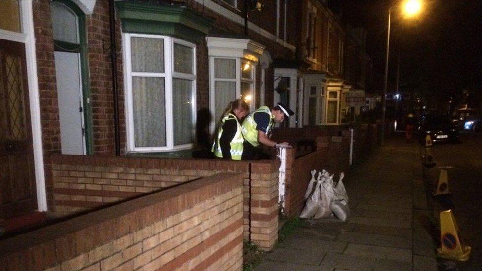 Two police officers at a house