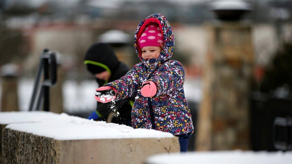 Girl playing in the snow in Texas