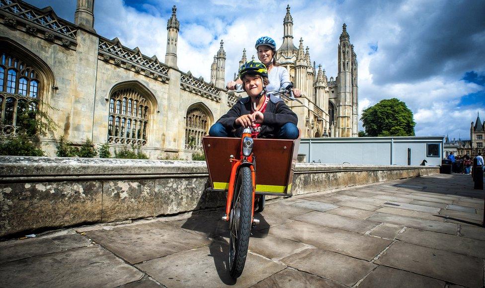 woman and boy in box bike