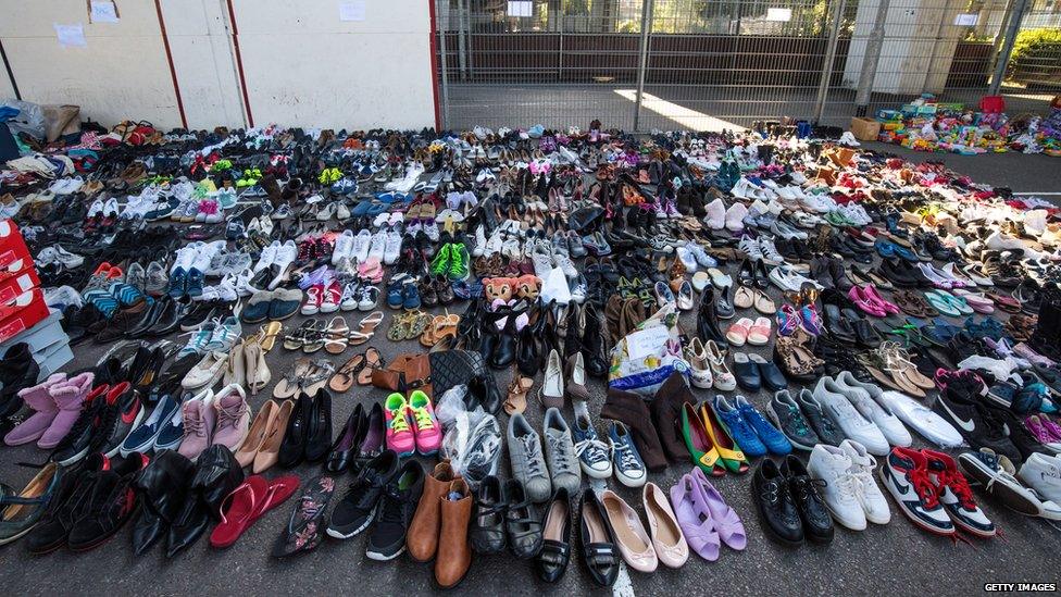 Donated shoes sit in the Westway Sports Centre near to the site of the Grenfell Tower fire