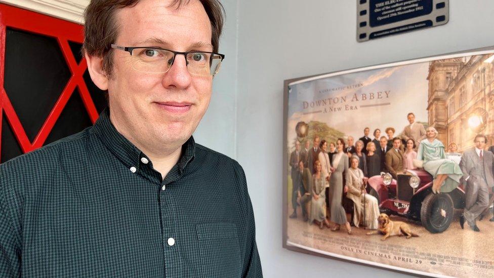 Michael Offord at the Electric Palace, Harwich, next to a Downton Abbey poster