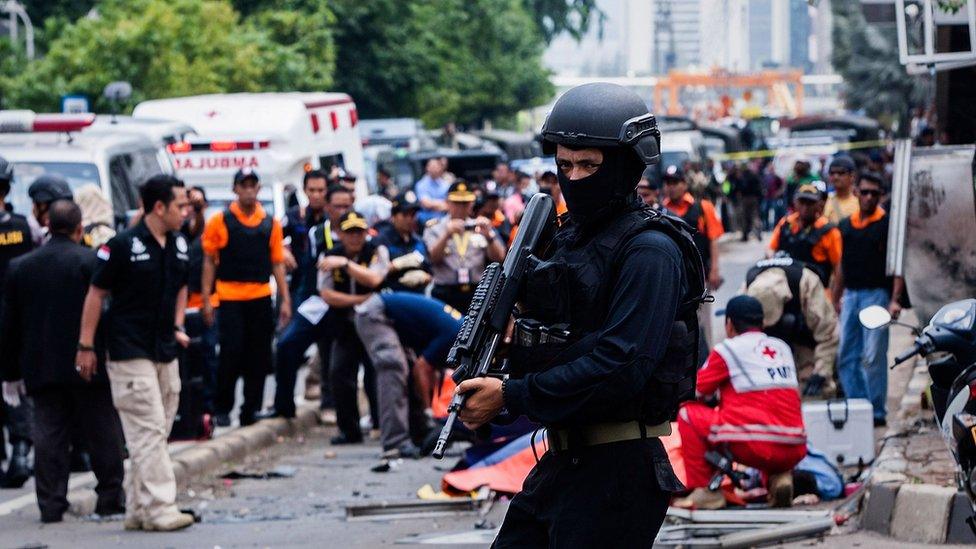 An Indonesian policeman stands guard in front of a blast site at the Indonesia capital Jakarta on January 14, 2016