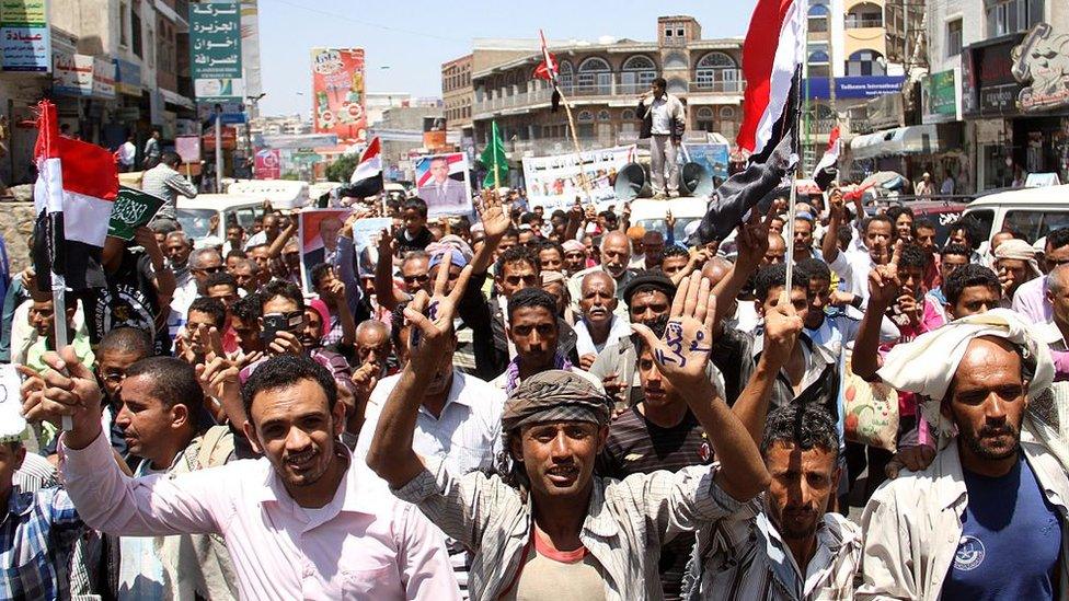 Yemenis shout slogans during a protest against the Houthi rebel movement in Taiz on 28 March 2015