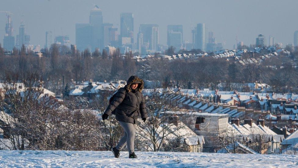 A woman walks over Blythe Hill, in south London