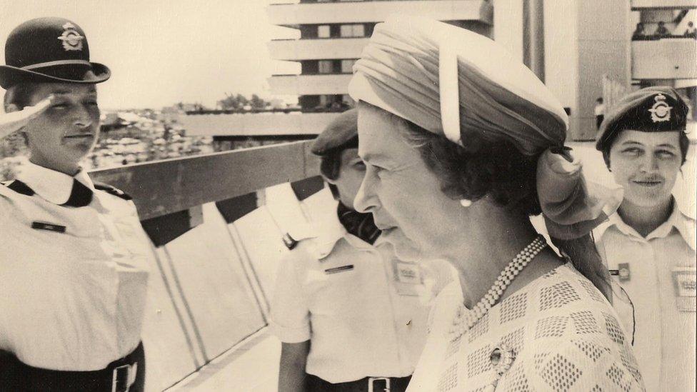 Pat Sargent and others saluting the Queen