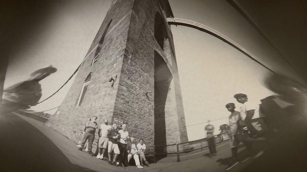 Clifton Suspension Bridge with some people stood next to it