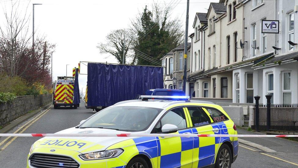 Police car outside the fire damaged house in Portadown