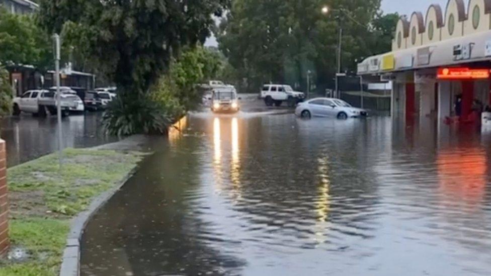 A car drives through a flooded street in Byron Bay, New South Wales, Australia, on 7 February