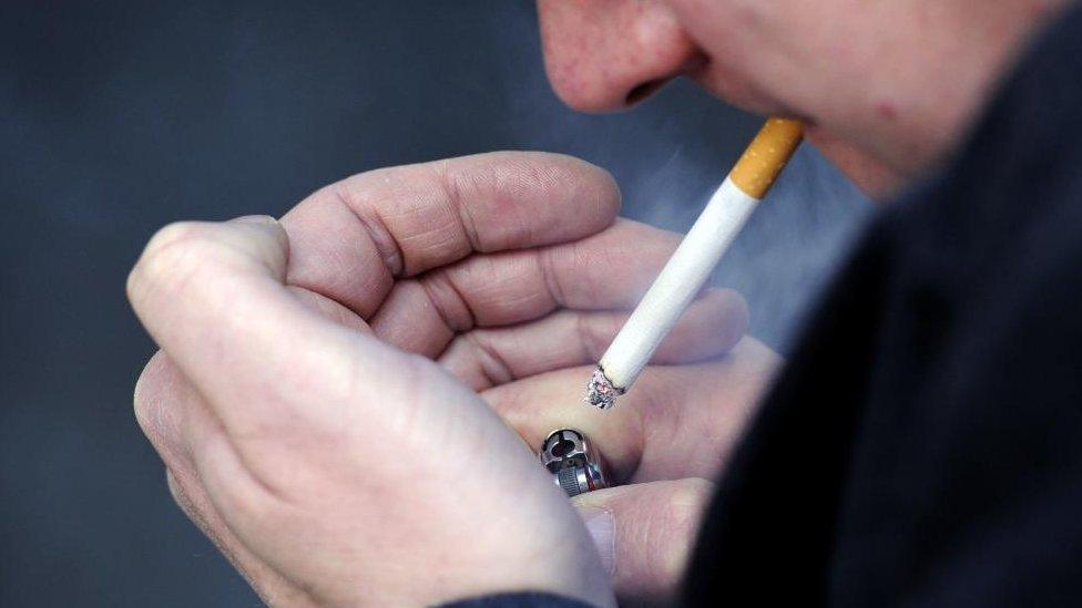 A close up of a man smoking