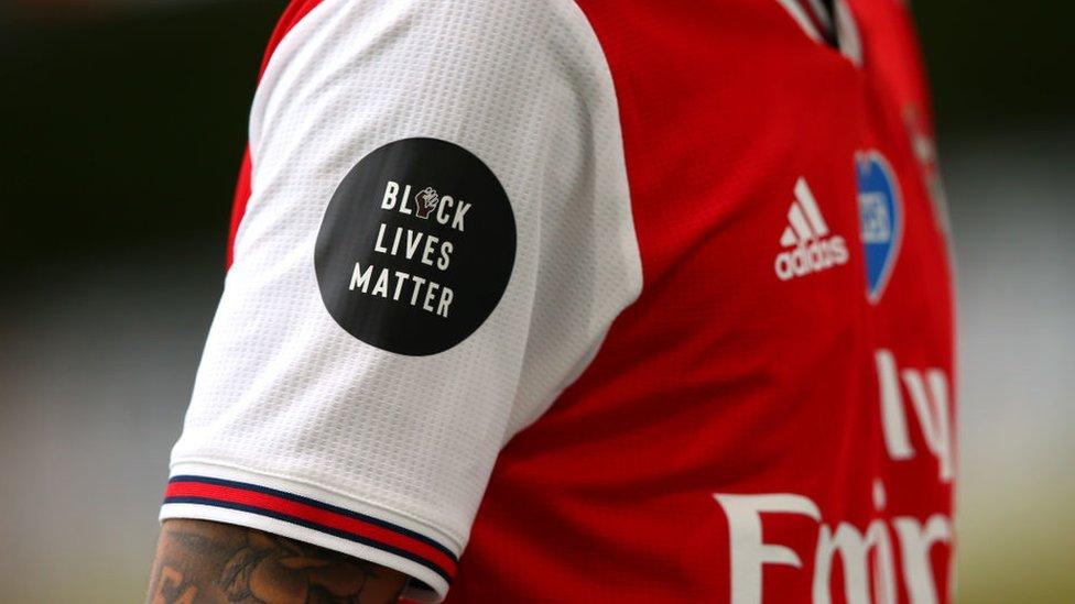 Arsenal player with Black Luves Matter logo on their shirt sleeve.