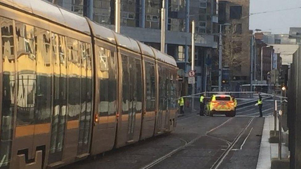 A Luas tram and police officers at the scene near Dublin's family courts