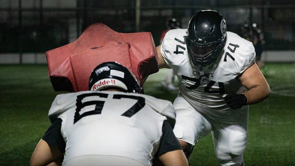 Men and women in Beijing suburb playing American football