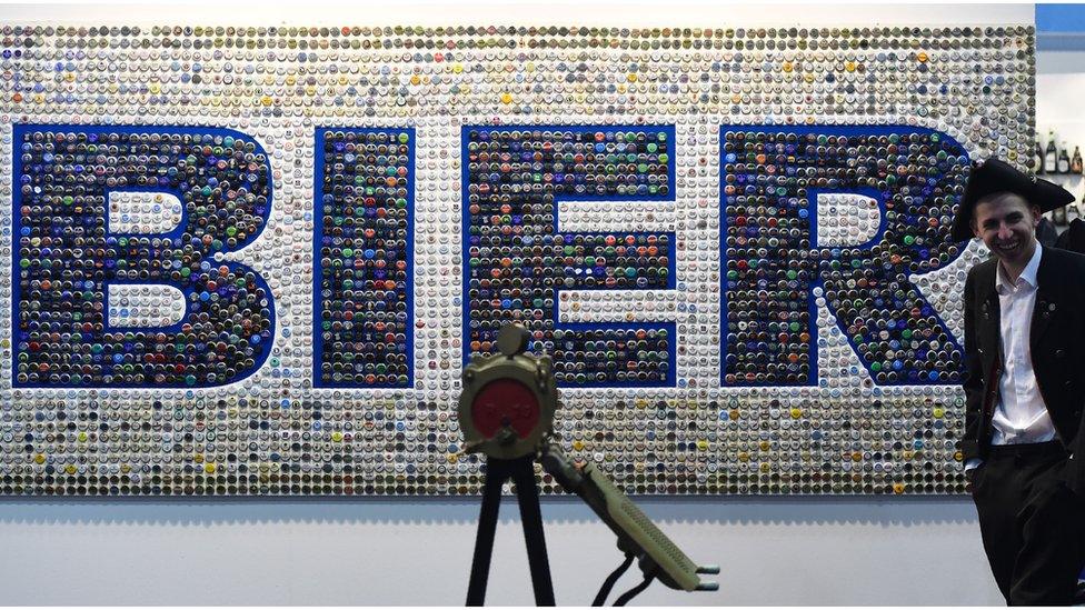 "Bier" (meaning beer) is spelled out in bottle tops on a wall at an agricultural fair in Berlin (15 January 2016)