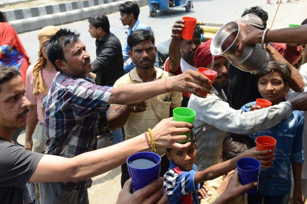 Indian volunteers distribute sweet water during a hot summer day, in Amritsar on June 2, 2019.