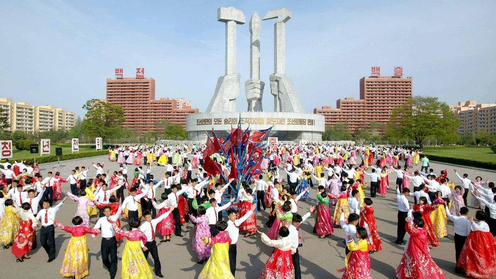 North Korean people dance during an event to mark the 85th anniversary of the country's army