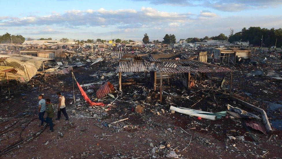 Rescuers search debris left by a huge blast in a fireworks market near Mexico City, on December 20, 2016