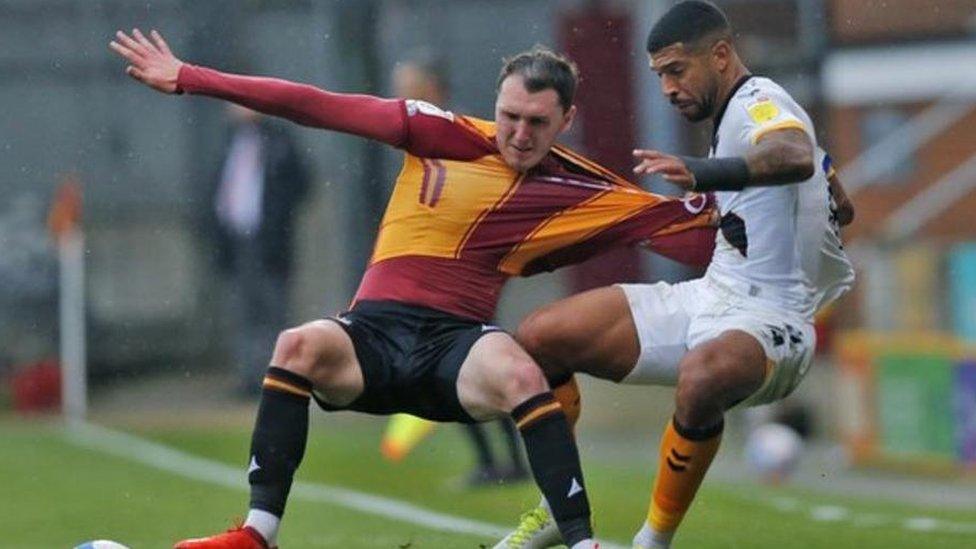 Newport's Joss Labadie (R) tussles with Callum Cooke of Bradford