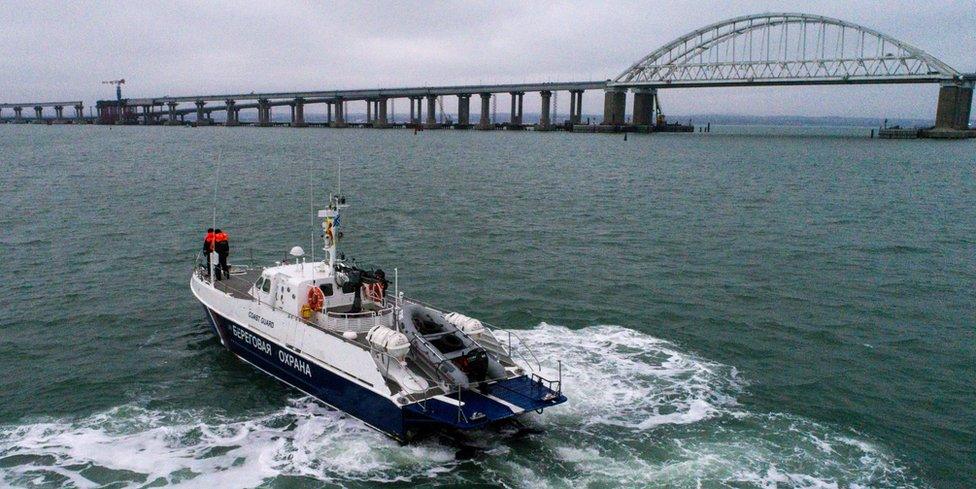 A Russian coastguard boat patrols near the Kerch Strait bridge