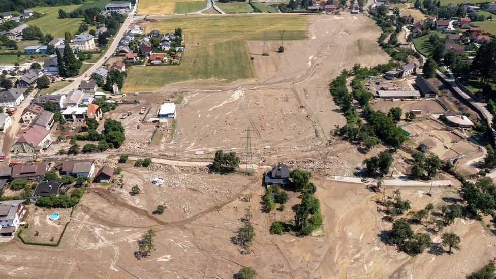 A town with roads and fields covered in mud.