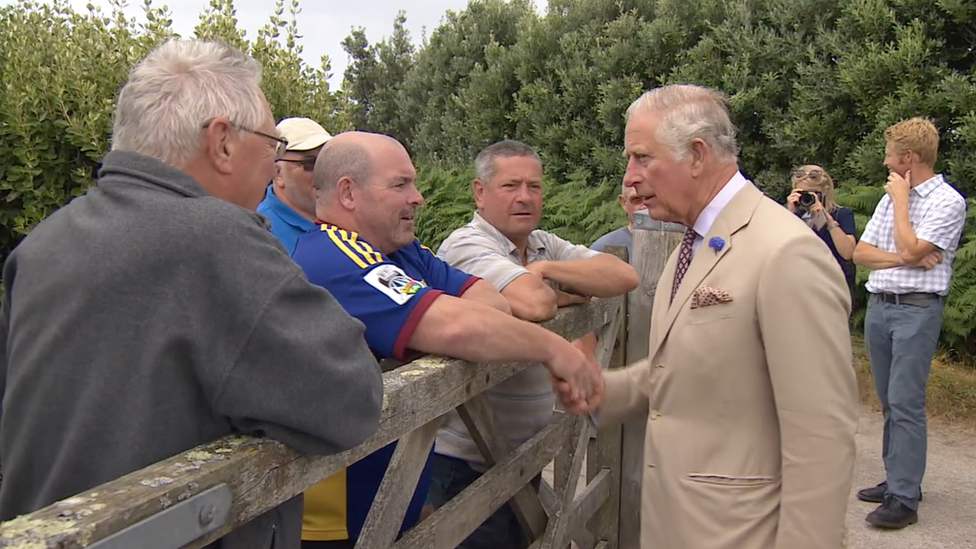 Prince of Wales shaking hands with local people