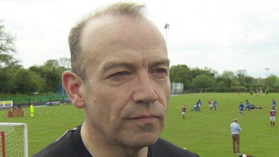 NI Secretary of State, Chris Heaton-Harris at a football pitch in south Antrim