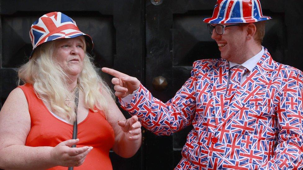 Friends Jane Bacon and Tristan Fox on a parade route during a Twelfth of July parade in Belfast