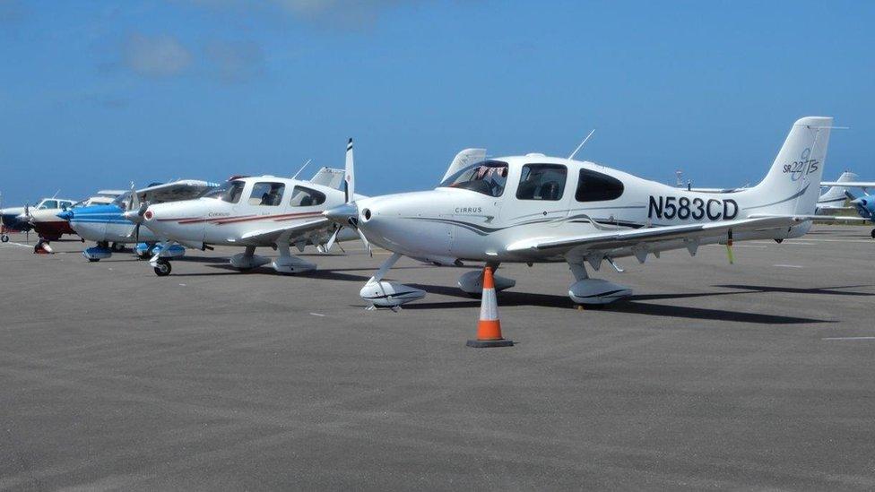 Light aircraft lined up at Guernsey Airport.