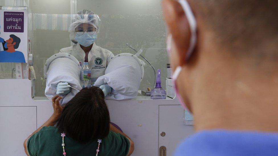 Thai people undergo a swab test for the COVID-19 testing to prevent the Omicron variant, at Mor Chit - Bangkok Bus Terminal, in Bangkok, Thailand, 29 December 2021