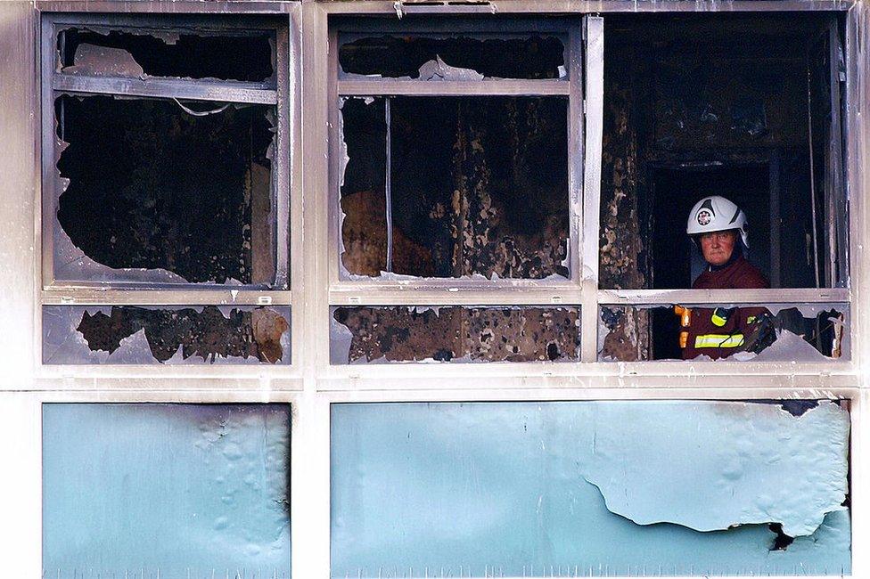 A fireman assesses damage after the Lakanal House fire in 2009