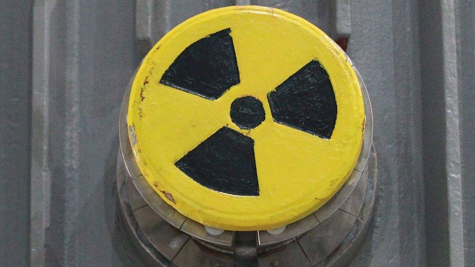 A symbol for radioactivity on a radioactively-contaminated container once used to transport nuclear fuel rods