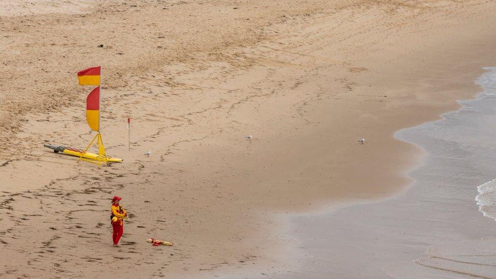 A lone lifeguard on a beach in southern New South Wales