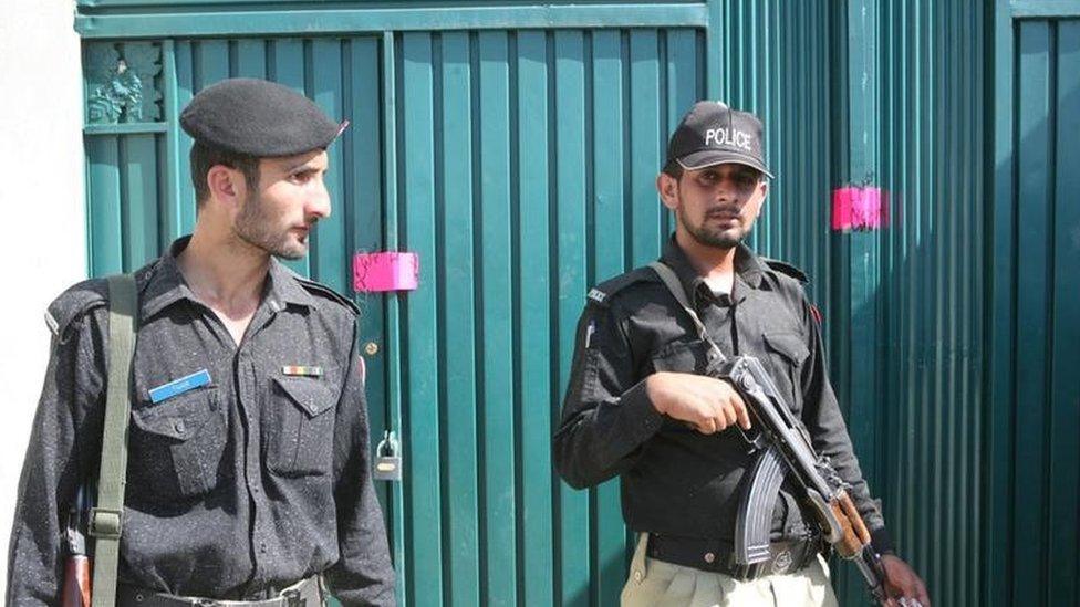 Pakistani police officers stand guard outside the compound where Osama bin Laden was hiding, is on the outskirts of the town of Abbottabad