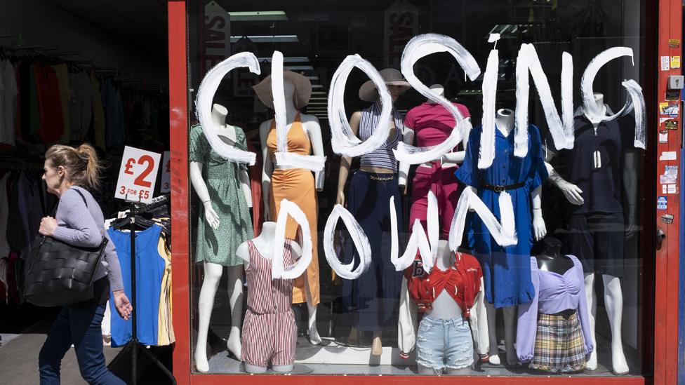 Shop closing down and selling cut price clothing in London