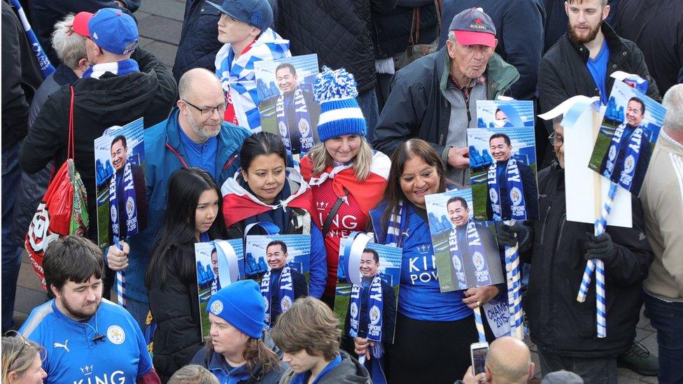 Fans with pictures of Vichai Srivaddhanaprabha