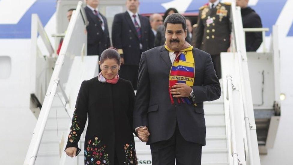 Venezuela's President Nicolas Maduro (R) holds the hand of his wife Cilia Flores while they disembark from a plane upon their arrival to participate in a special session of the United Nations Human Rights Council in Geneva, Switzerland on 12 November, 2015