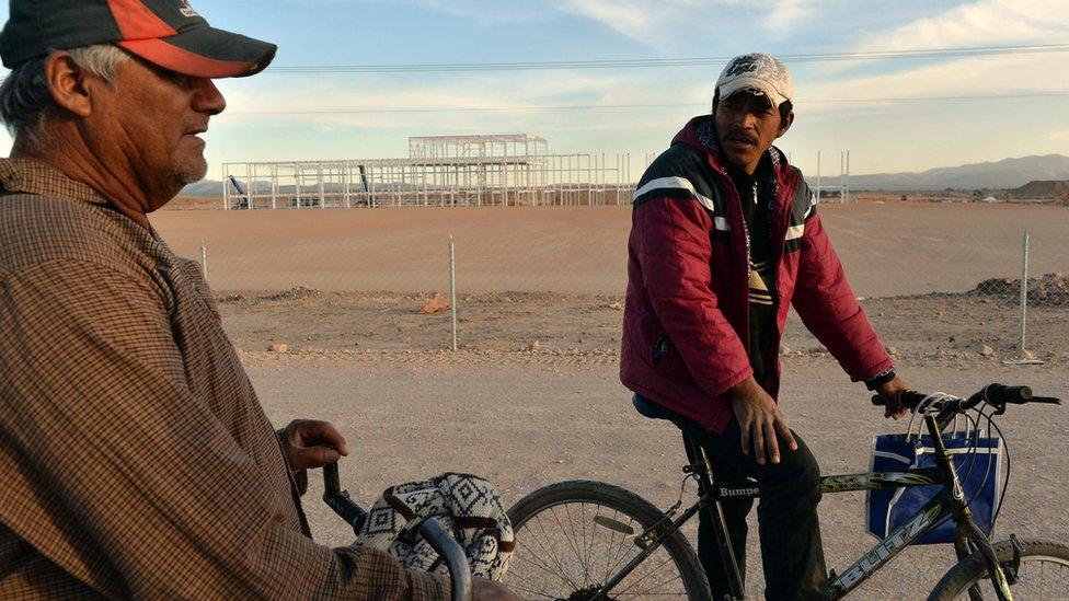 Security guards ride their bicycles around unfinished buldings remaining in the site of a called off Ford car factory in Villa de Reyes, near San Luis Potosi, Mexico, on January 10,