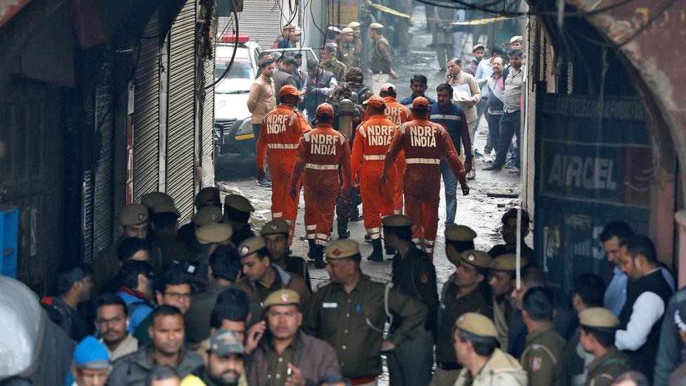 Members of India"s National Disaster Response Force (NDRF) head towards the site of the fire