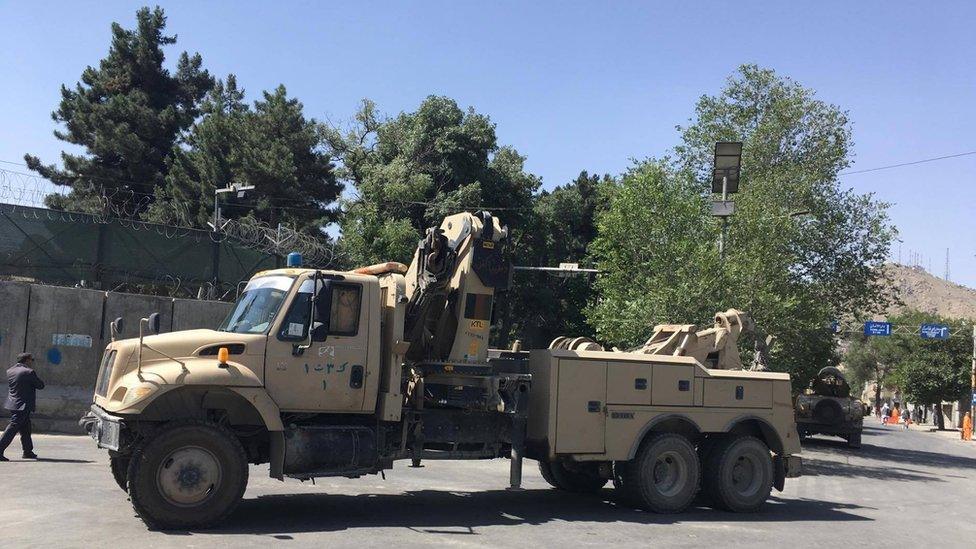 Afghan police at the site of the cleared protest