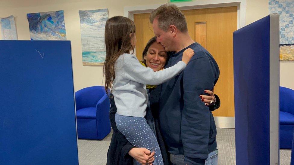 Nazanin Richard and Gabriella hugging at airport